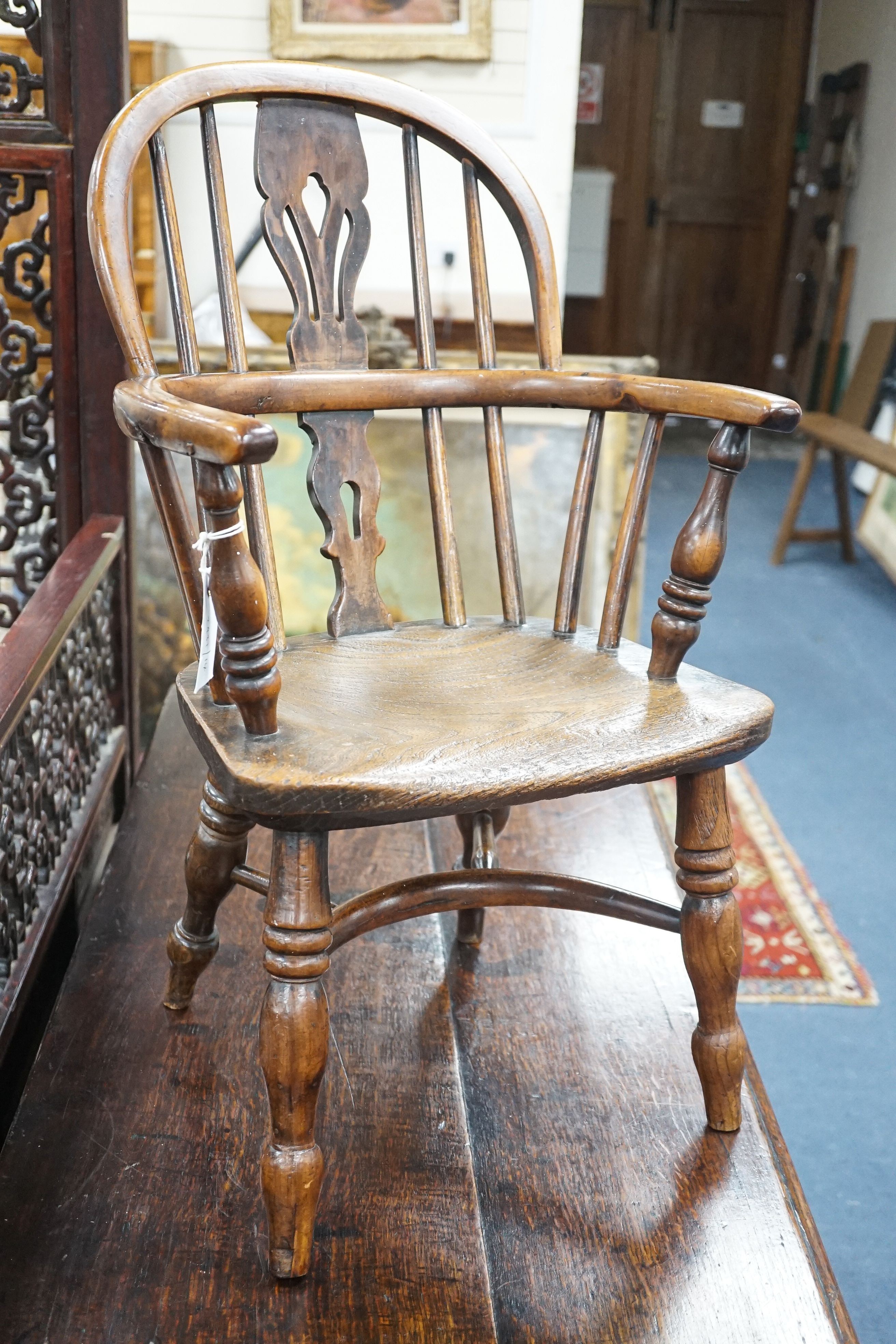 A 19th century Midlands area yew and elm Windsor child's elbow chair with crinoline stretcher, width 37cm, depth 44cm, height 65cm
